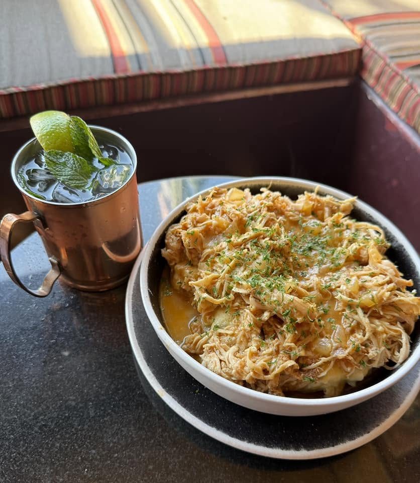 A copper mug mule beside a loaded bowl