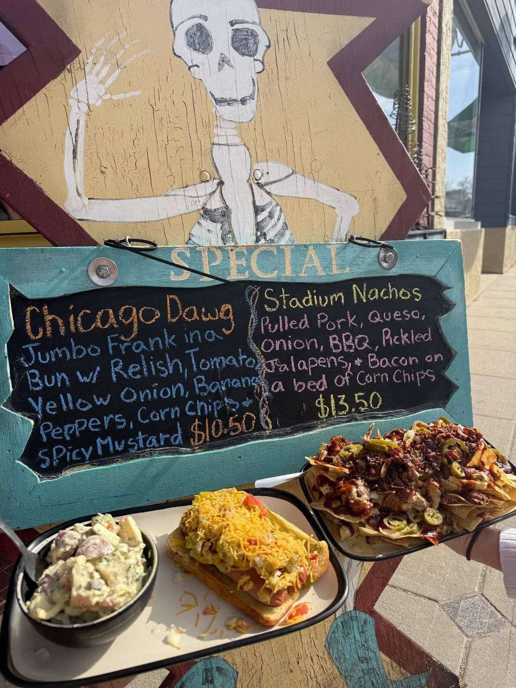 The specials board with a Chicago Dawg and Stadium Nachos