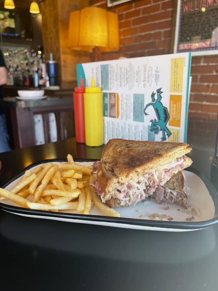 A grilled sandwich with fries