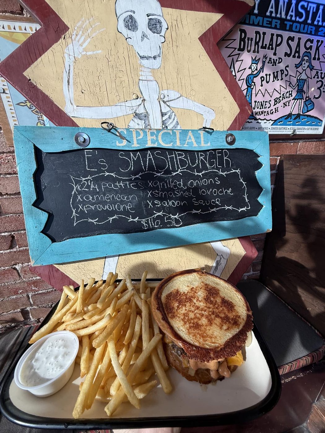 The specials board with a smashburger and fries